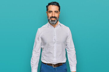 Middle aged man with beard wearing casual white shirt looking positive and happy standing and smiling with a confident smile showing teeth