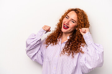 Naklejka premium Young ginger caucasian woman isolated on white background raising fist after a victory, winner concept.