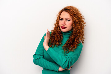 Young ginger caucasian woman isolated on white background confused, feels doubtful and unsure.