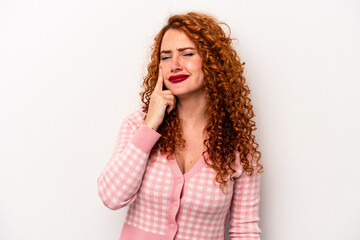 Young ginger caucasian woman isolated on white background crying, unhappy with something, agony and...