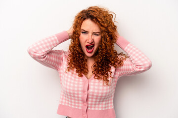 Young ginger caucasian woman isolated on white background screaming, very excited, passionate, satisfied with something.