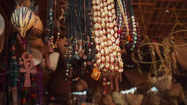 Egyptian Bazaar souvenir shop, close up of beads and necklaces moving in the wind. 
Static slow shot.