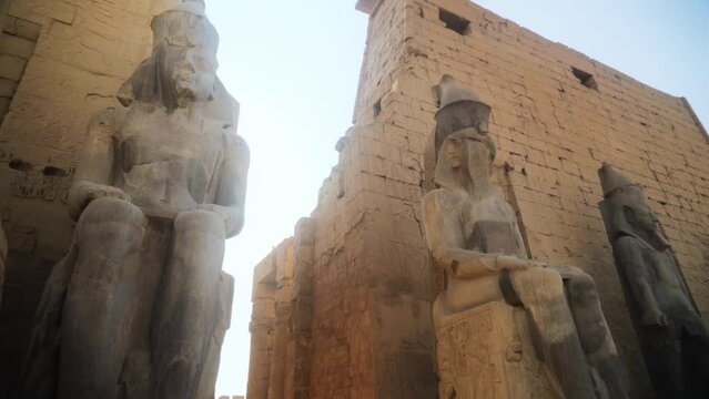 Large statues of Kings in the Karnak Temple of Luxor, Egypt.
Slow camera movement from a low angle.