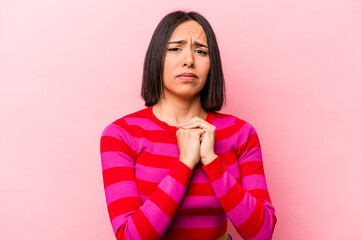 Young hispanic woman isolated on pink background scared and afraid.