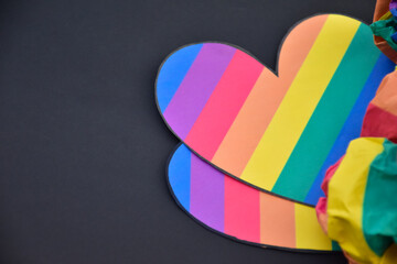 Rainbow colored paper cut out in the shape of a heart, concept for lgbtq+ community celebration in pride month and special lgbtq+ occasion around the world.