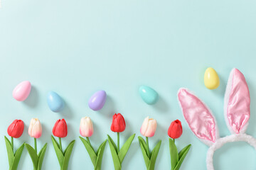 Easter banner with tulips and eggs. Copy space. Flat lay, top view