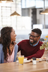 Love and laughter. Cropped shot of a young couple enjoying each others company.