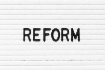 Black color letter in word reform on white felt board background