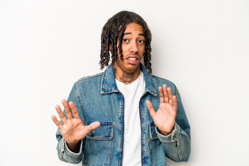 Young African American man isolated on white background rejecting someone showing a gesture of...