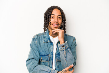 Young African American man isolated on white background smiling happy and confident, touching chin with hand.