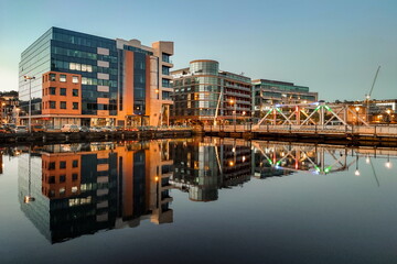 Sunset in Cork City Ireland business and classic buildings with reflection on the river