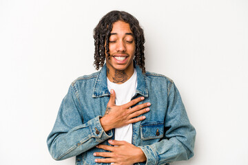 Young African American man isolated on white background laughs happily and has fun keeping hands on...