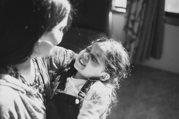 Mamá e hija sonriendo, jugando y dándose cariño