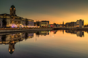 Sunset in Cork City Ireland business and classic buildings with reflection on the river