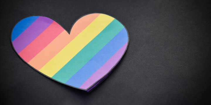 Rainbow colored paper cut out in the shape of a heart, concept for lgbtq+ community celebration in pride month and special lgbtq+ occasion around the world.
