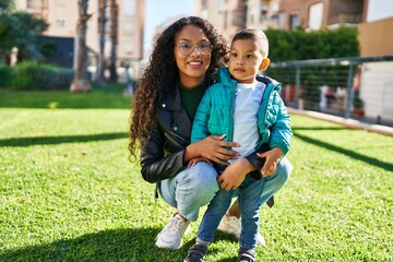 Fototapeta premium Mother and son hugging each other standing at park