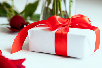 White Gift box with red ribbon on white background for giving gift concept