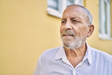 Obraz premium Senior man smiling confident at street