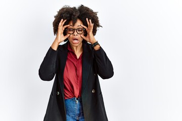 African american woman with afro hair wearing business jacket and glasses trying to open eyes with...