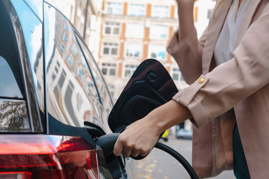 Woman refueling car at gas station