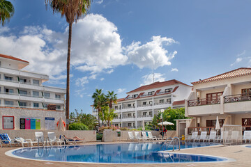 Hotel Apartamentos Andorra, Las Americas, Tenerife, Canary Islands, Spain - December 3, 2021: views of the holiday and residential complex featuring a large swimming pool and surrounding decking area