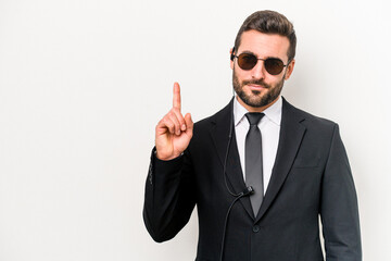 Young caucasian bodyguard man isolated on white background showing number one with finger.