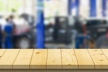 Empty wood table top with car service centre auto repair workshop blurred background