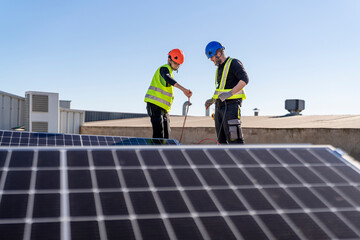 Technicians working with wires at solar power station