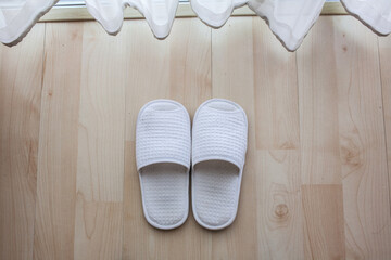 white slippers on wooden floor