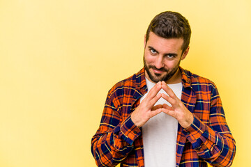 Young caucasian man isolated on yellow background making up plan in mind, setting up an idea.