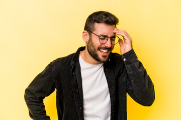 Young caucasian man isolated on yellow background joyful laughing a lot. Happiness concept.