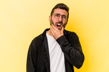 Young caucasian man isolated on yellow background having a strong teeth pain, molar ache.