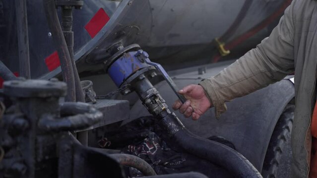 Man pulling the lever on a plant. Close-up of mechanic pulling the gear