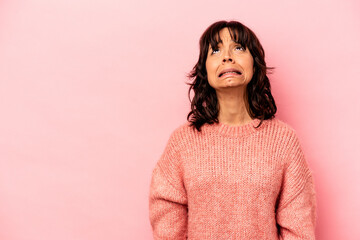Fototapeta premium Young hispanic woman isolated on pink background shouting very angry, rage concept, frustrated.
