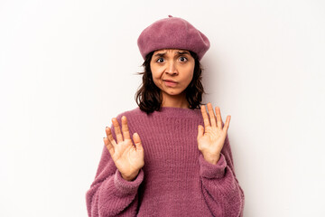 Young hispanic woman isolated on white background being shocked due to an imminent danger