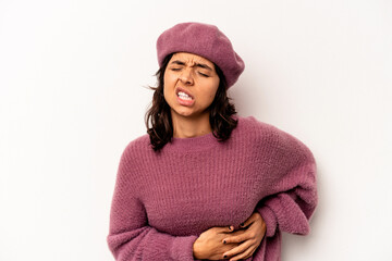 Young hispanic woman isolated on white background having a liver pain, stomach ache.