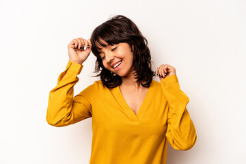 Young hispanic woman isolated on white background celebrating a special day, jumps and raise arms with energy.