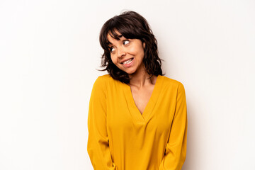 Obraz premium Young hispanic woman isolated on white background laughs and closes eyes, feels relaxed and happy.