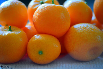 Ripe tangerines are on the table. The ripening season of tropical citrus fruits. Close-up.