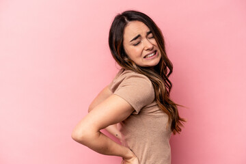 Naklejka premium Young caucasian woman isolated on pink background suffering a back pain.