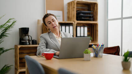 Middle age hispanic woman business worker working at office