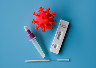 Selective focus picture of covid-19 test kit showing positive after self swab test been done.