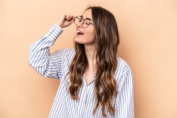 Young caucasian woman isolated on beige background celebrating a victory, passion and enthusiasm, happy expression.