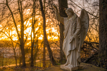 Germany, Hesse, Brechen, Outdoor angel statue at sunrise