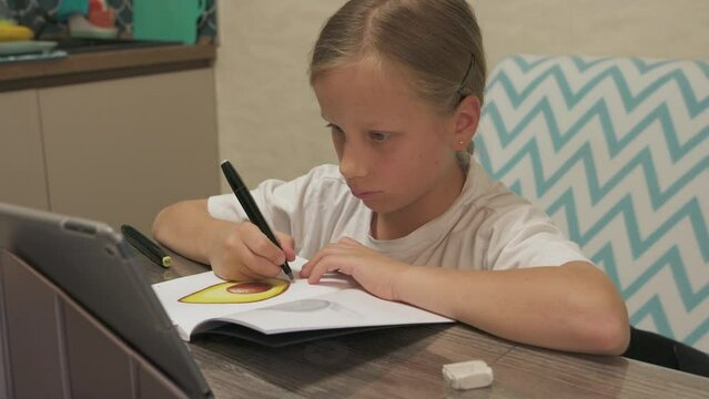ten year old girl learns to draw online using internet and tablet