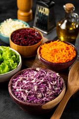 Fresh grated vegetables in bowls on the table. Healthy food.