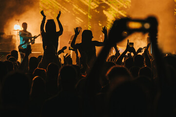 Two woman in the crowd at a music festival