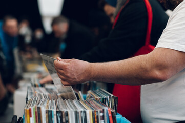Man hands browsing vinyl album in a record store