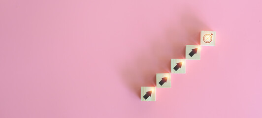 Investment concept. wooden block and the target goal with the upper arrow on pink background. Banking and financial, passive income, future returns, growth in assets, and success, save money.