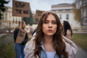 Young caucasian woman looking at camera on manifestation against war